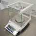 Mettler Toledo ME403E precision balance ka right angle view, jisme right glass draft shield panel, weighing pan, digital screen, aur front control keypad saaf dikhai de rahe hain.   