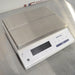Right three-quarter angle product view of a Mettler Toledo MS12001L/03 high-precision toploading balance, featuring a stainless steel weighing platform, white body, digital display panel, and function keys on a stainless steel lab bench