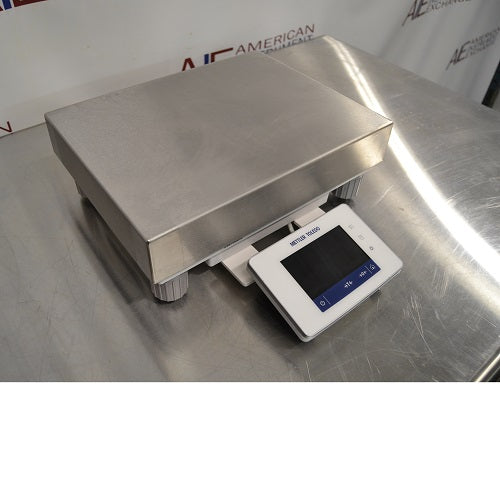 Left angled perspective view of Mettler Toledo XSR10001L precision balance showing stainless steel weighing platform and front digital control panel