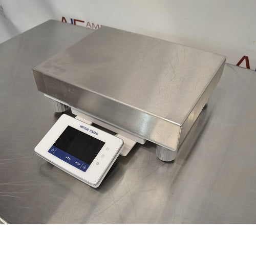 Right angled perspective view of Mettler Toledo XSR10001L precision balance showing stainless steel weighing platform and front digital control panel