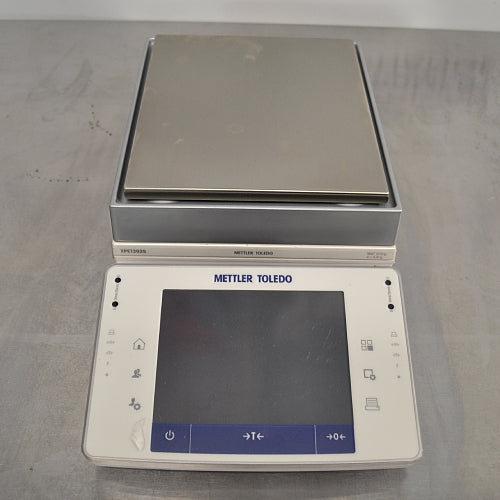 Mettler Toledo XPE1202S precision balance ka front angle view, jisme stainless steel weighing pan, touch screen display terminal, aur Mettler Toledo branding saaf dikhai de rahe hain.