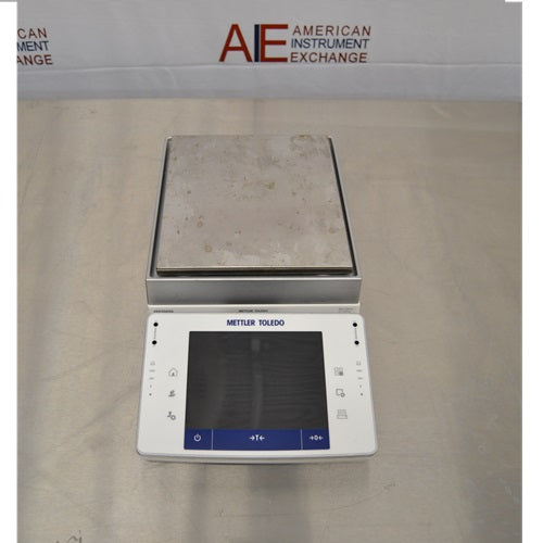 Top view of Mettler Toledo XPE2002S precision balance displaying stainless steel square weighing pan and front touchscreen control terminal