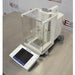 Left angled perspective view of Mettler Toledo XPE26 microbalance showing glass draft shield chamber, main housing, leveling feet, and touchscreen control unit