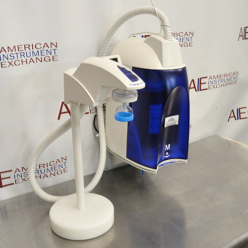 Right angled perspective view of a Millipore Direct-Q 3UV-R remote water purification system on a stainless steel surface, featuring its main purification housing with a blue translucent cover and the connected remote dispenser on its stand