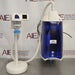 Front eye-level view of a Millipore Direct-Q 3UV-R remote water purification system on a stainless steel surface, featuring its main blue and white purification unit and a connected remote dispenser arm mounted on a standalone base stand