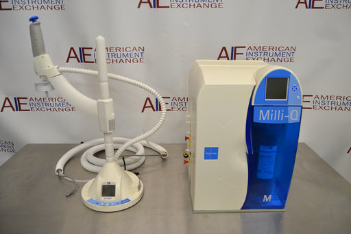 Angled perspective view of a Millipore Milli-Q Integral 15 water purification system showing the main processing unit alongside its linked remote dispensing arm and base control unit on a stainless steel surface