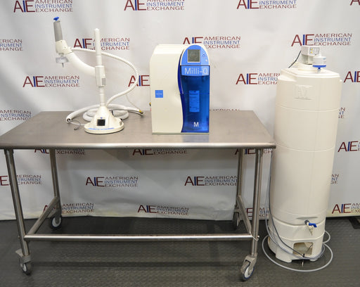 Front eye-level view of a Millipore Milli-Q Integral 15 water purification system featuring its main unit on a stainless steel table, remote dispensing arm, and a large storage reservoir tank
