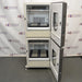 Front product view of a New Brunswick Innova 42R stacked refrigerated incubator shaker system with both outer doors swung open, revealing the internal stainless steel chambers, internal platform mechanisms, and back wall venting