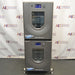 Front product view of a New Brunswick Innova 42R stacked refrigerated incubator shaker system, featuring two vertically mounted grey units with curved doors, central glass windows, digital control displays, and leveling feet
