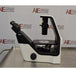 Left profile view of a Nikon Eclipse Ts2 inverted microscope on a stainless steel surface, featuring its black-and-white ergonomic frame, stage, coarse and fine focus controls, overhead condenser column, and the left-facing binocular viewing head