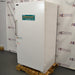 Norlake flammable material storage laboratory refrigerator ka right angle view, jisme right side panel, solid white door, warning sign, aur wooden shipping pallet saaf dikhai de rahe hain.