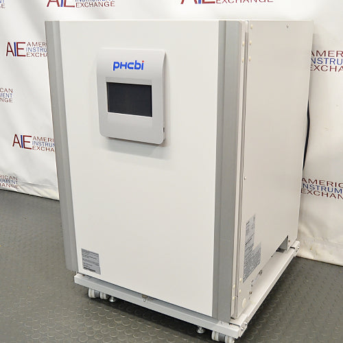 Studio right three-quarter angle product view of a PHCBi Cell-IQ Series CO2 laboratory incubator against a branded backdrop, highlighting its white outer body, vertical silver corner pillars, central door-mounted digital touchscreen interface, right side panel labels, and mobile roller base