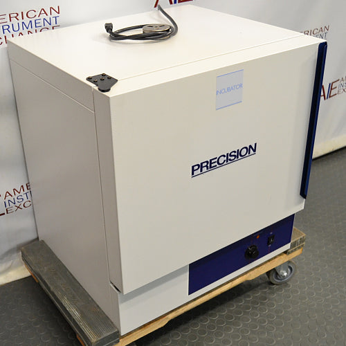 Front angled perspective view of a Precision 3EG incubator resting on a wooden pallet with casters, highlighting its white exterior housing, blue accent stripe on the door edge, and lower control panel