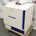 Right angled perspective view of a Precision 3EG incubator on a wheeled wooden pallet, highlighting its white outer casing, blue vertical handle accent, and bottom control panel