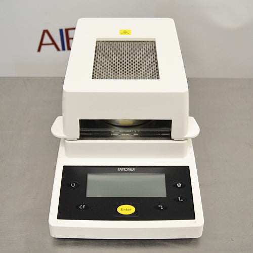 Front high angle product view of a Sartorius MA35 infrared moisture analyzer, showcasing its white housing, top mesh ventilation panel, sample chamber opening, and angled front control interface