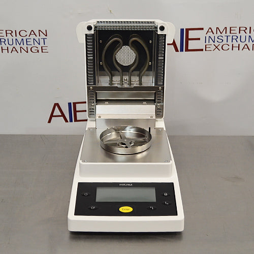 Front product view of a Sartorius MA35 infrared moisture analyzer with the heating chamber lid open, revealing the internal dual infrared heating elements, sample pan holder, and front control console
