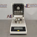 Front product view of a Sartorius MA35 infrared moisture analyzer with the heating chamber lid open, revealing the internal dual infrared heating elements, sample pan holder, and front control console