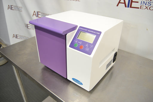 Front angled perspective view of a Seward Stomacher 400 Circulator lab blender, showcasing its white cabinet, purple paddle door and control panel overlay, and LCD screen resting on a stainless steel work table