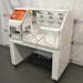 Sheldon BACTRON I anaerobic environmental chamber ka right angle view, jisme right side housing panel, glove ports, internal chambers, aur caster wheel stand base saaf dikhai de rahe hain.   
