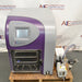 Elevated front product view of an SP VirTis AdVantage Pro laboratory freeze dryer, featuring a purple-and-gray chassis, digital control touchscreen, internal shelving chamber, and paired vacuum pump assembly on a wooden pallet
