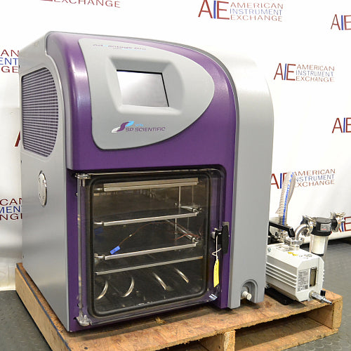 Three-quarter angle product view of an SP VirTis AdVantage Pro laboratory freeze dryer, showcasing the purple side accent, side panel cooling vents, digital touchscreen, internal shelf chamber, and connected vacuum pump system on a wooden pallet