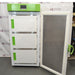 Front angle product view of a Stirling Ultracold SU780XLE ultra-low freezer with its main outer door open, revealing three inner compartment doors with green handles and a green top housing panel