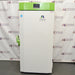 Front angle product view of a Stirling Ultracold SU780XLE ultra-low freezer, featuring a white body, a bright green top housing with an integrated digital display, a matching green door handle, and the Stirling Ultracold logo on the front door