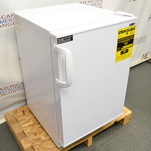 Front angled perspective view of a Summit undercounter all-freezer on a wooden pallet, showcasing its white cabinet body, solid front door with an ergonomic handle, and a yellow EnergyGuide label
