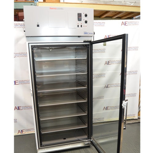 Thermo Forma Model 3920 environmental chamber with open glass door revealing stainless steel interior chamber and multiple adjustable wire shelves
