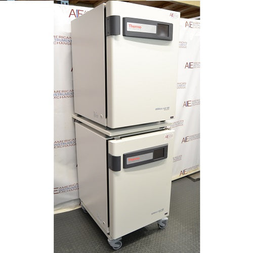 Left angled perspective view of a stacked pair of Thermo Heracell VIOS 160i CO₂ incubators on a rolling stand with closed doors showing touch display panels