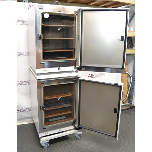 Front perspective view of a stacked pair of Thermo Heracell VIOS 160i CO₂ incubators on a rolling stand with both doors open revealing internal shelving and chambers