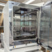 Three-quarter product view of a single Thermo Heracell VIOS 250i CO2 incubator with its outer door open, showcasing the polished stainless steel interior chamber, adjustable wire shelves, and inner glass door