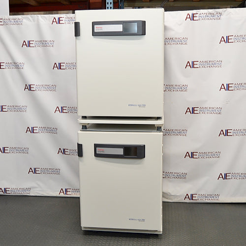 Front product view of a stacked dual Thermo Heracell VIOS 250i CO2 incubator system, showcasing two identical units mounted vertically with top-mounted digital display panels in a warehouse setting