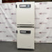 Front product view of a stacked dual Thermo Heracell VIOS 250i CO2 incubator system, showcasing two identical units mounted vertically with top-mounted digital display panels in a warehouse setting
