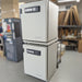 Low angle product view of a stacked dual Thermo Heracell VIOS 250i CO2 incubator system in a warehouse, highlighting the vertical configuration, digital control interfaces, and side panels