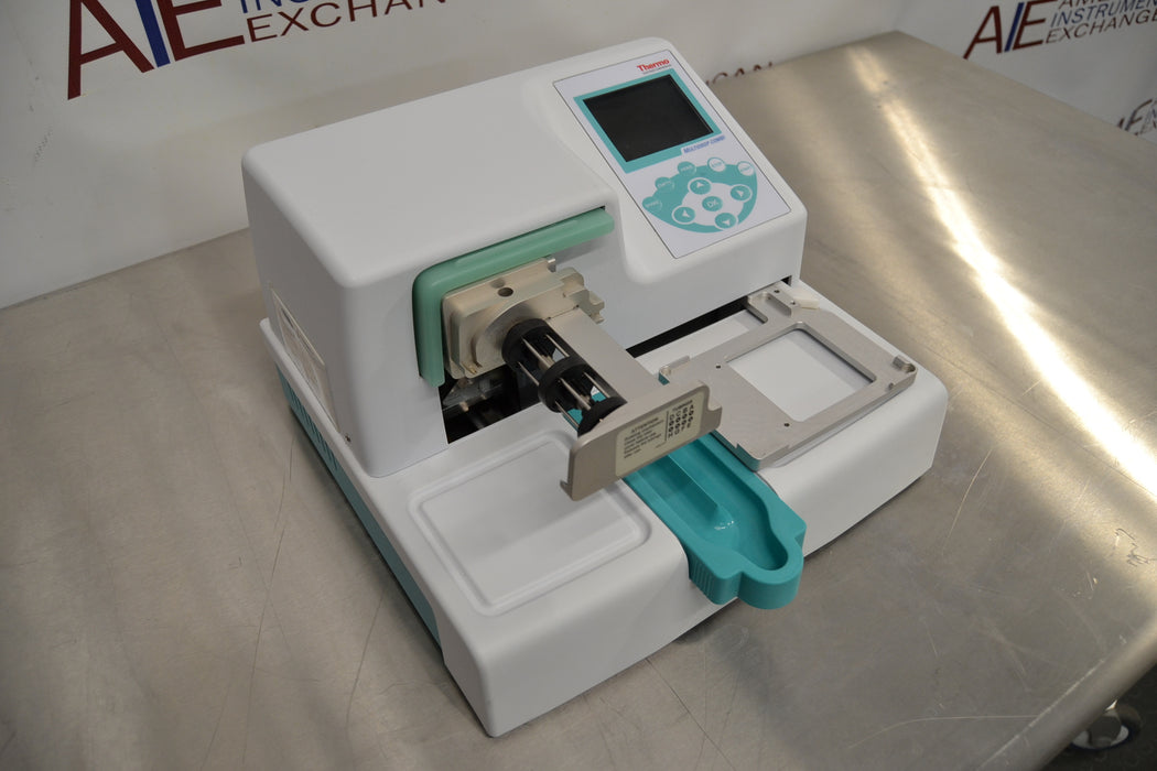Right three-quarter angle product view of a Thermo Multidrop Combi reagent dispenser, showcasing its white housing, digital display interface, and dispensing cassette setup