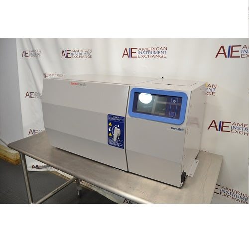 Right angled perspective view of a Thermo Scientific CryoMed controlled rate freezer resting on a stainless steel surface showcasing its digital control panel and main chamber housing