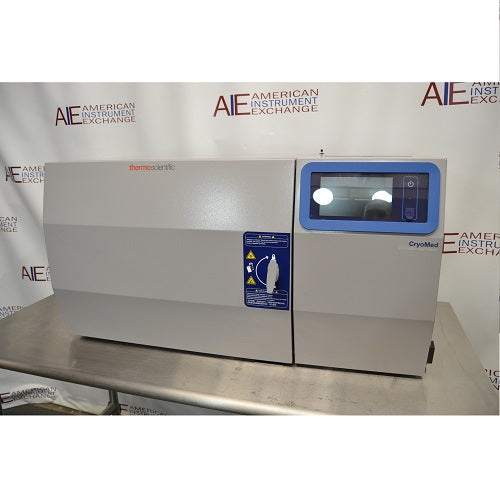 Front eye-level view of a Thermo Scientific CryoMed controlled rate freezer resting on a stainless steel surface featuring a front-loading door and digital touchscreen control panel