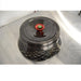 Angled perspective view of a Thermo Scientific Fiberlite F13-14x50cy carbon fiber centrifuge rotor resting on a stainless steel surface featuring a red and green central locking lid mechanism