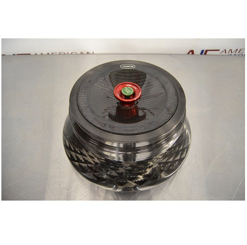 Top-down view of a Thermo Scientific Fiberlite F13-14x50cy carbon fiber centrifuge rotor resting on a stainless steel surface featuring a red and green central locking lid mechanism