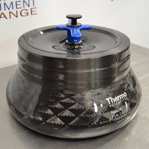 Front angled perspective view of a Thermo Scientific Fiberlite F14-14x50cy carbon fiber centrifuge rotor, highlighting its dark woven composite body, secure lid, and blue locking handle assembly