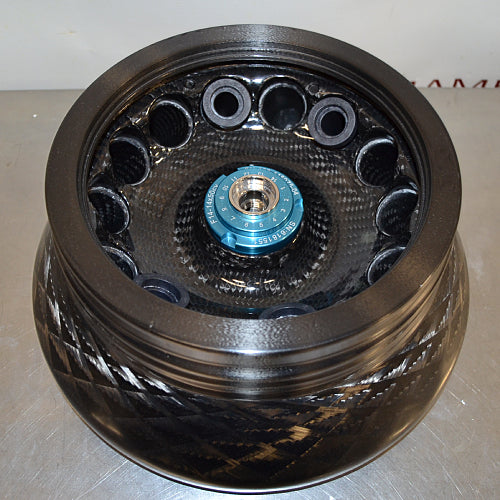 Top-down view of an open Thermo Scientific Fiberlite F14-14x50cy carbon fiber centrifuge rotor, revealing the internal sample tube cavities, woven composite interior, and central locking hub mechanism