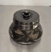 Angled perspective view of a Thermo Scientific Fiberlite F21S-8x50Y carbon fiber centrifuge rotor resting on a stainless steel surface showcasing its tapered body and central lid