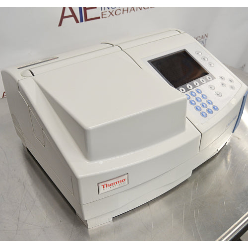Three-quarter angle product view of a Thermo Scientific Helios Omega UV-Vis spectrophotometer, showcasing the sample compartment lid, integrated display, and control keypad on a stainless steel counter