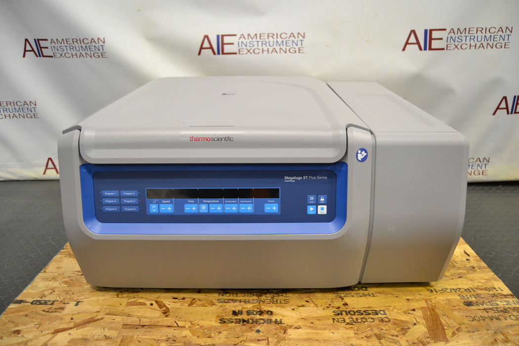 Front eye-level view of a Thermo Scientific Megafuge ST4R Plus MD refrigerated centrifuge with its lid closed, highlighting the main digital interface control panel, branded housing, and gray benchtop cabinet resting on a wooden pallet