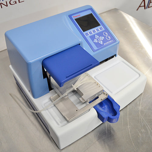 Left three-quarter angle product view of a Thermo Scientific Multidrop Combi nL Type 838 reagent dispenser, highlighting its blue and white housing, control panel, and dispensing head setup