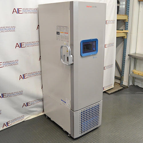 Three-quarter angle view of Thermo Scientific RLE30086D ultralow laboratory freezer, highlighting its white insulated body, locking handle mechanism, digital touchscreen, and lower vented compressor grille
