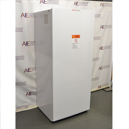 Left angled perspective view of white Thermo Scientific TSV20FPSA11 convertible refrigerator freezer with closed door showing front warning label