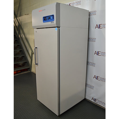 Front three-quarter product view of a Thermo Scientific TSX2320FD high-performance laboratory freezer, highlighting its grey upright cabinet, vertical door handle, and top control console