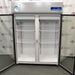 Front view of a Thermo Scientific TSX5005CA high-performance laboratory refrigerator with both glass doors swung fully open, revealing adjustable interior wire shelves and a bright white compartment lining